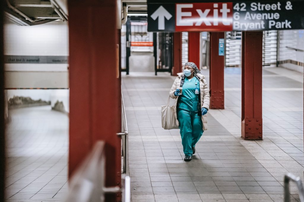 nurse walking through the train station