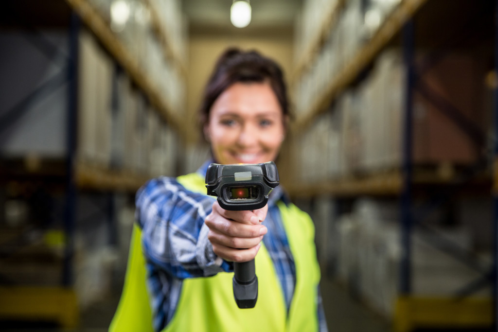 employee holding a barcode scanner