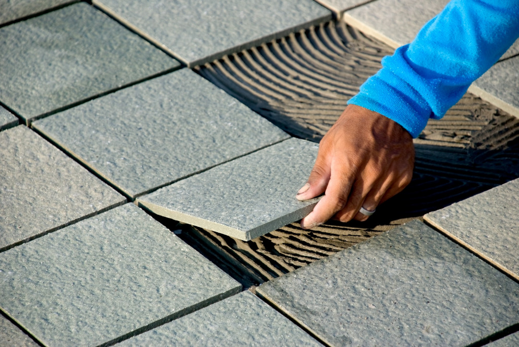 installing tiles on wet cement