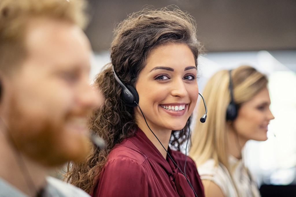 Portrait of confident woman working in a call center while looking at camera